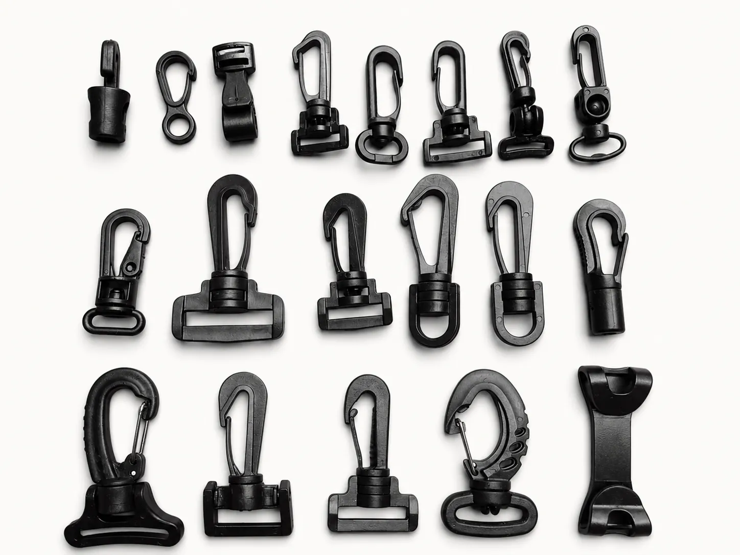 Assorted black plastic swivel hooks and snap clips for straps and lanyards