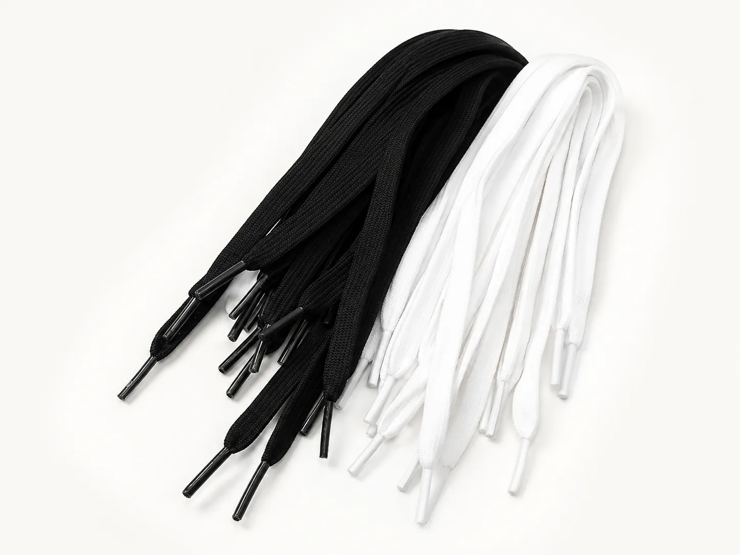 Black and white flat shoelaces with finished tips