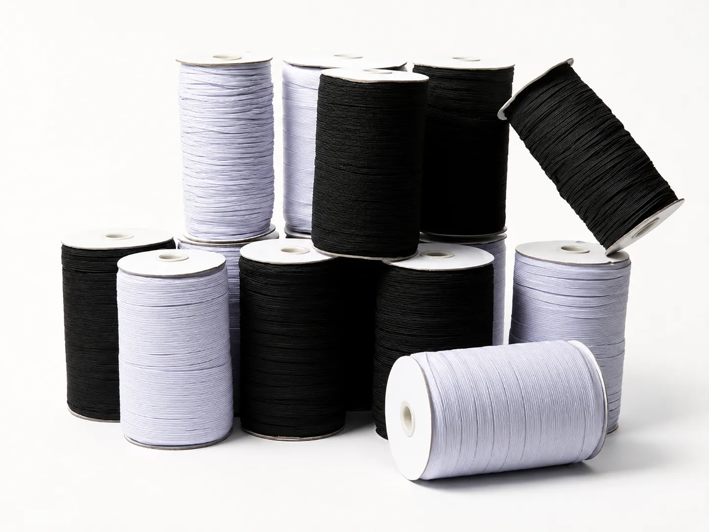 Black and white elastic cords wound on large spools
