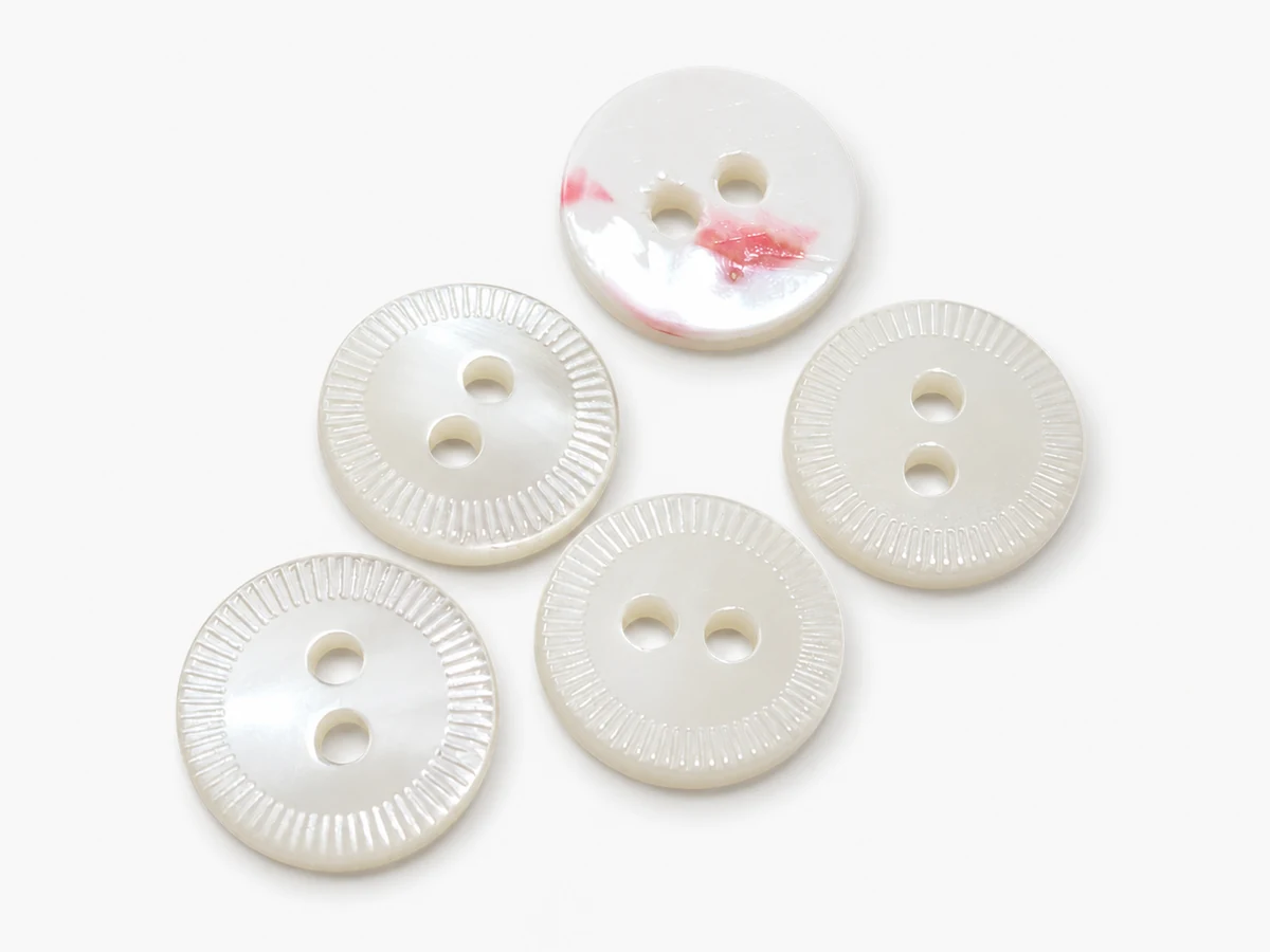 two hole ridged rim shell buttons in white mother of pearl finish