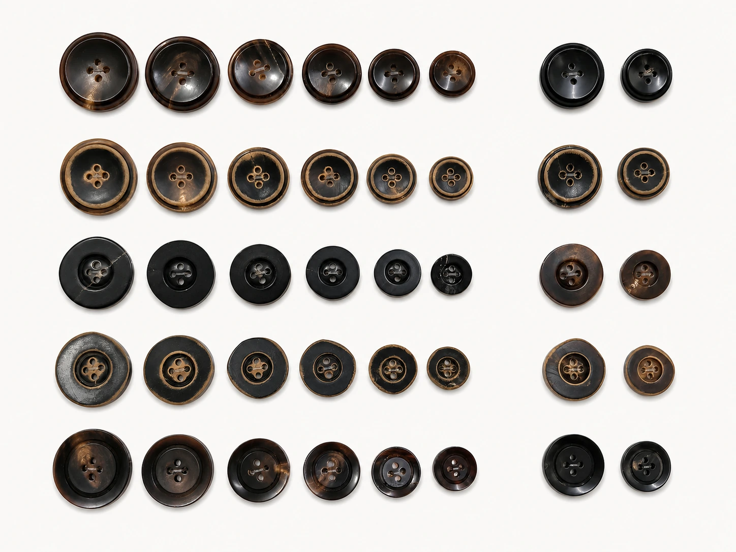 mixed polished and burnt edge genuine horn buttons arranged by size