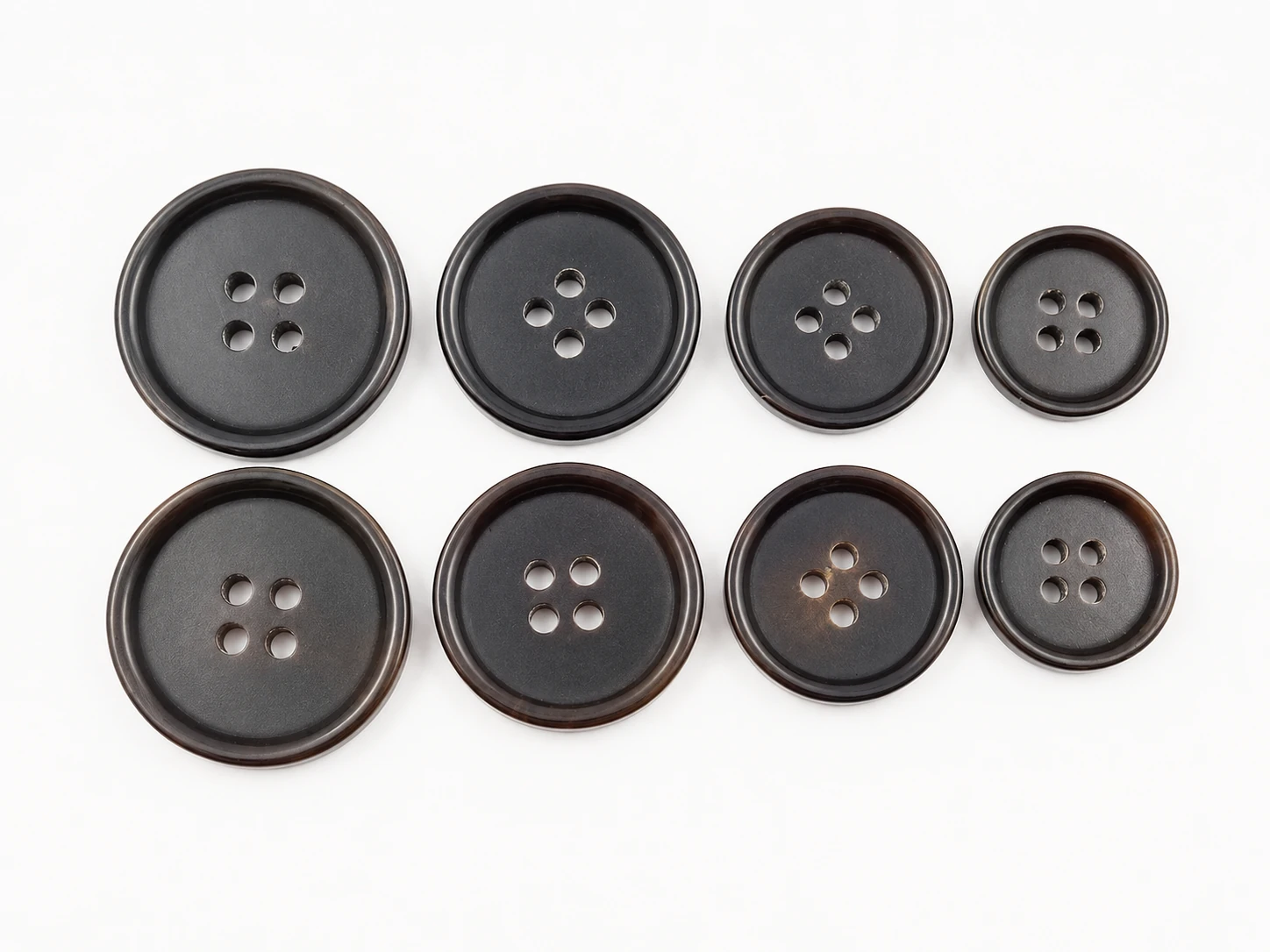 dark brown genuine horn buttons shown in coordinated size set for suiting and coats