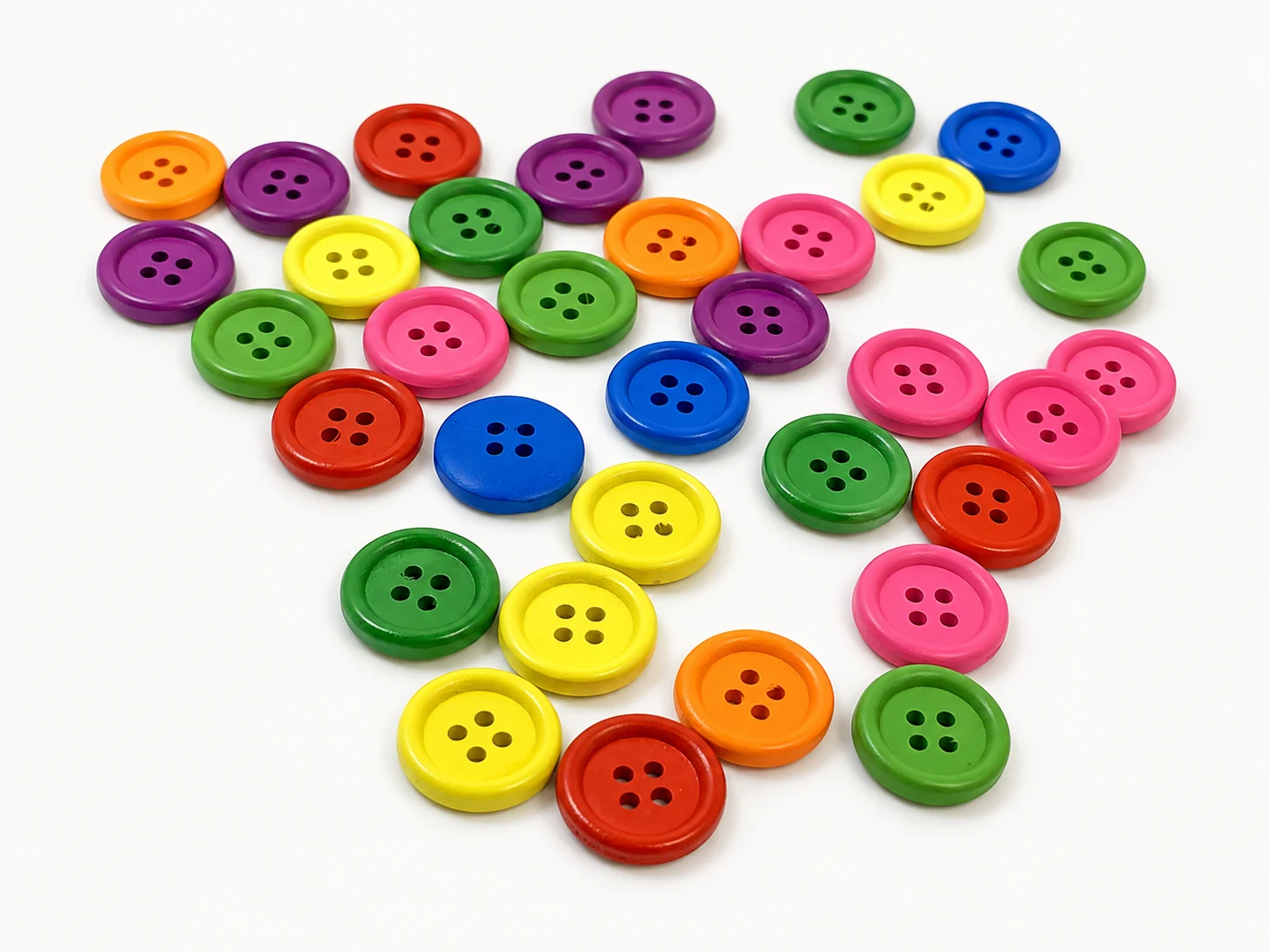 bright colorful painted wooden buttons in yellow pink blue green purple orange and red